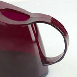 Arrosoir transparent rouge - L'arroseur arrosé